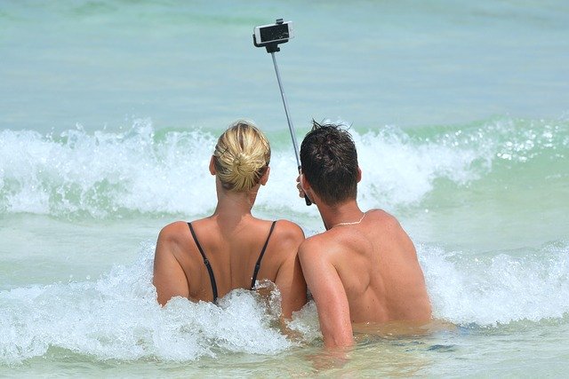 Couple taking a selfie by the beach